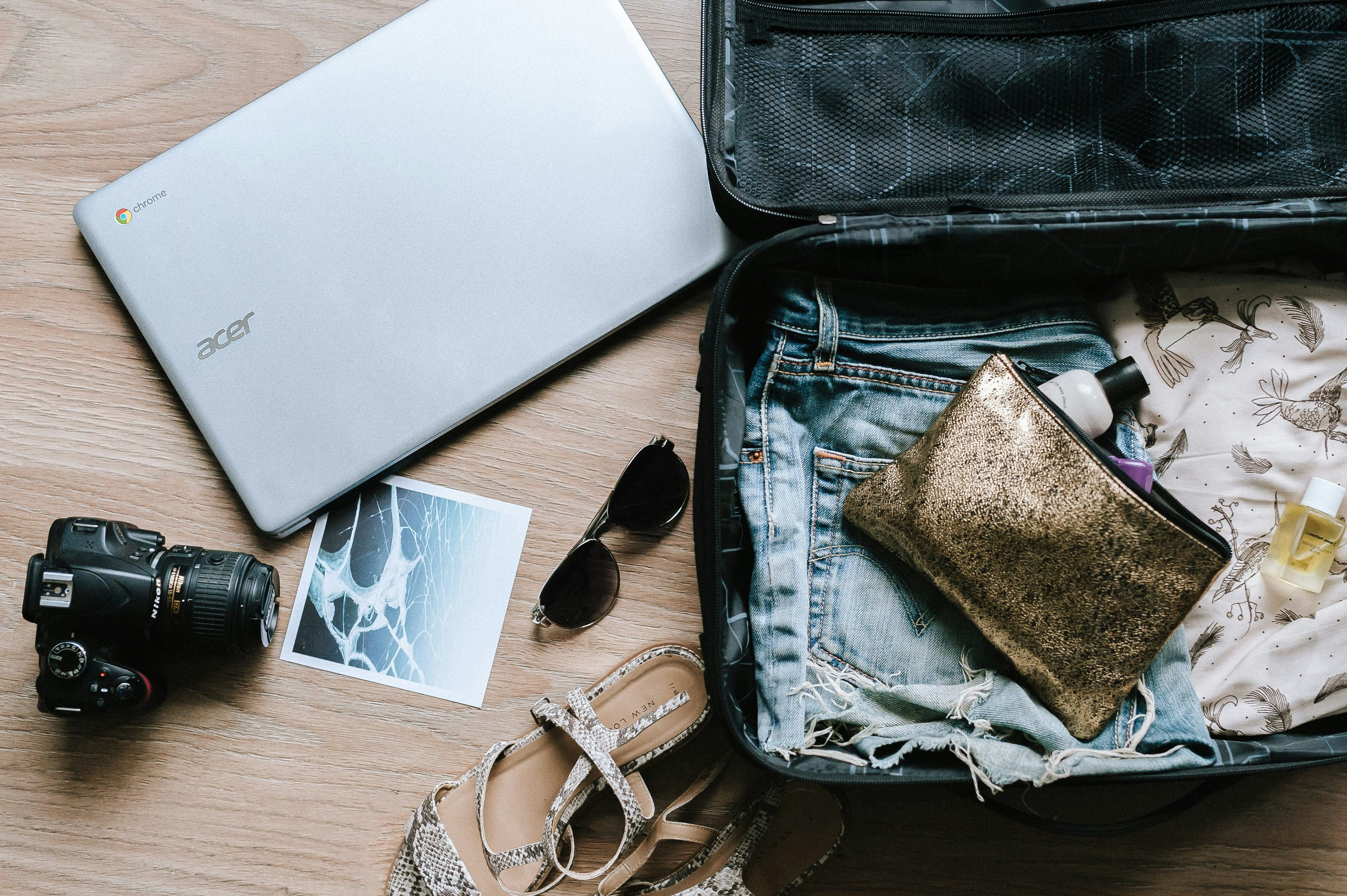 Traveler organizing a personal-item bag beside an airport window
