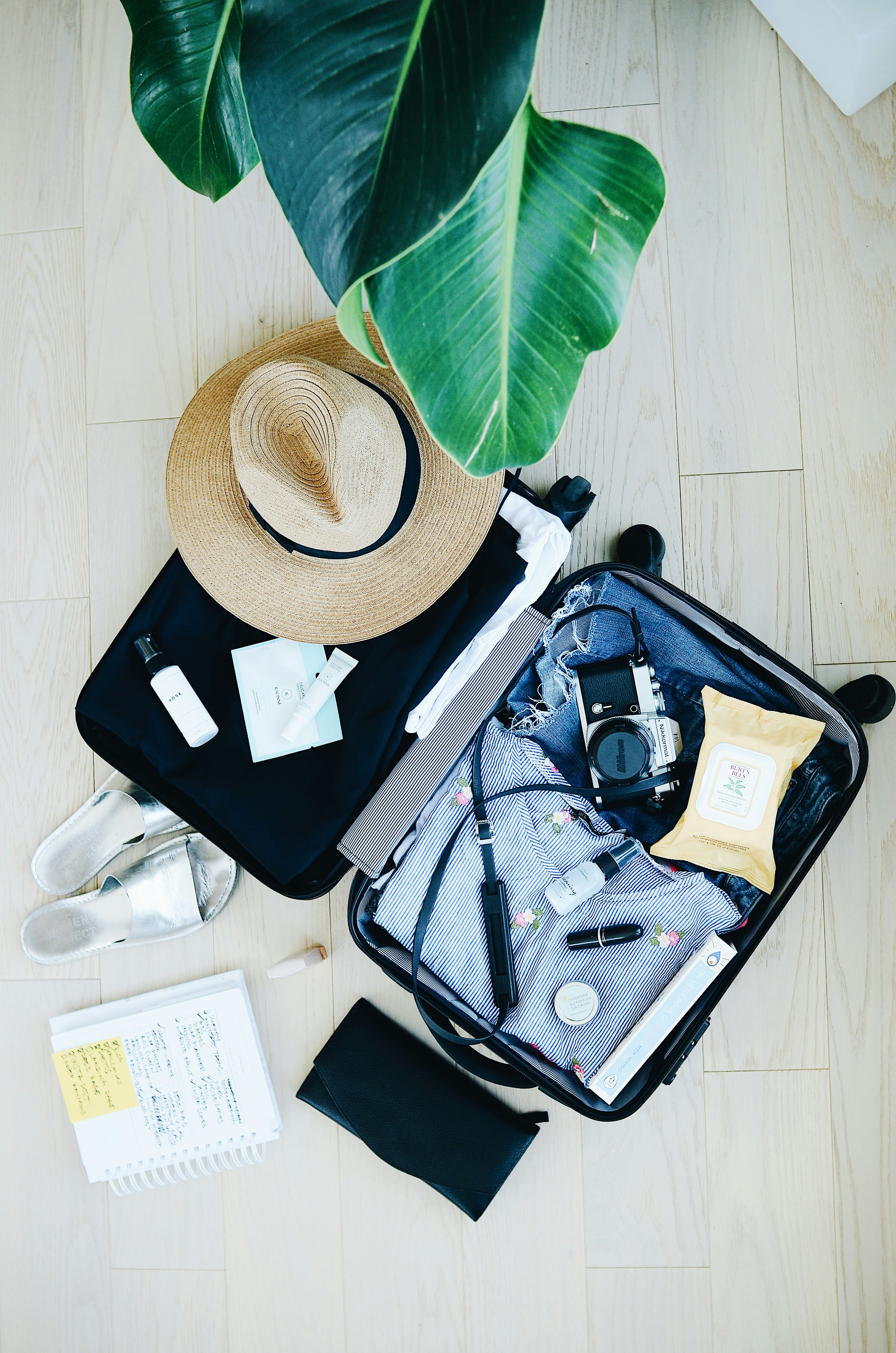 Traveler arranging packing cubes inside an open suitcase on a bed